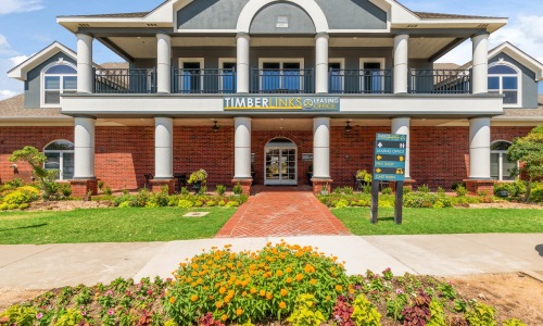 a building with columns and a sign in front of it