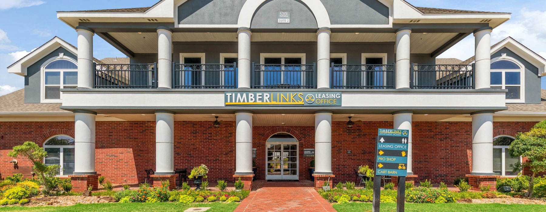 a building with columns and a sign in front of it